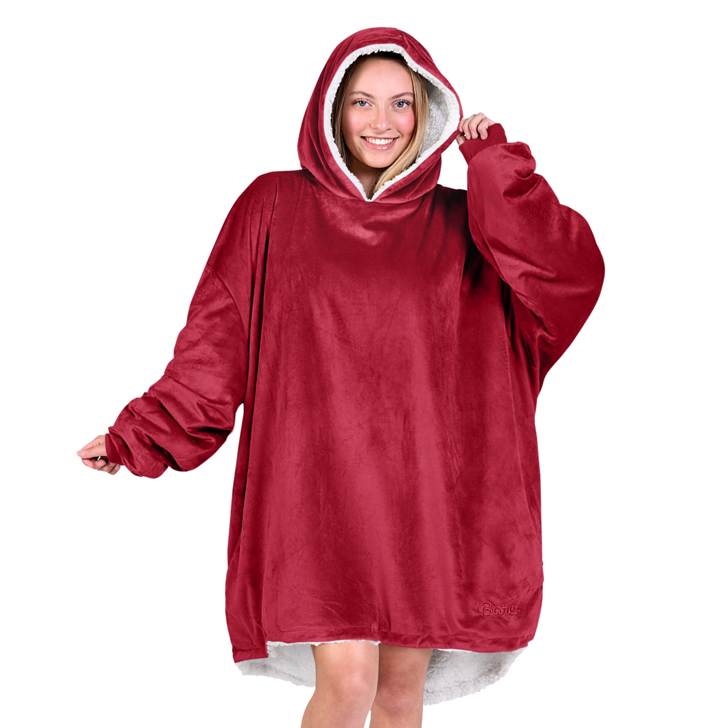 An adult with a hooded wearable blanket on