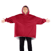 An adult with a wearable blanket on