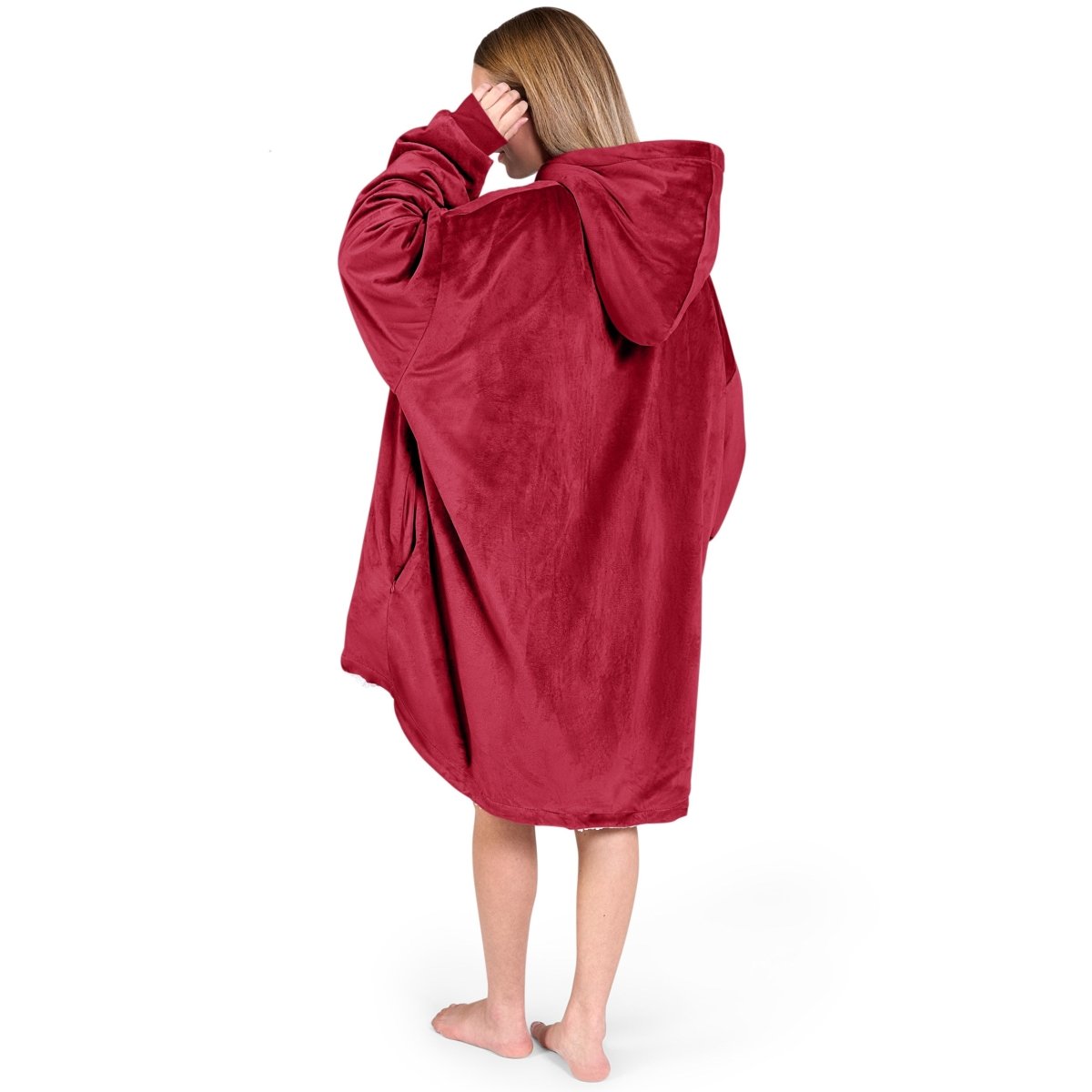 An adult with a sherpa wearable blanket on