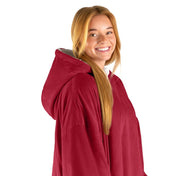 An adult with a hooded wearable blanket on