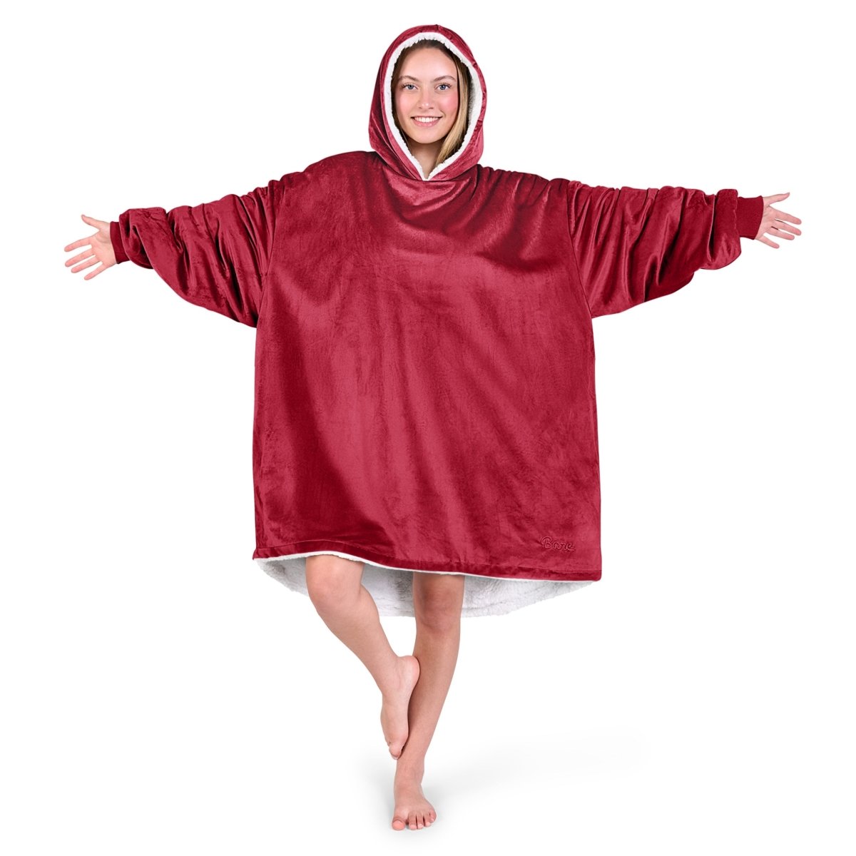 An adult with a hooded wearable blanket on