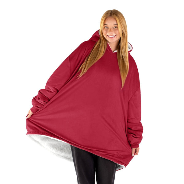 An adult with a sherpa wearable blanket on