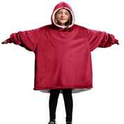 A child is wearing a sherpa wearable blanket and is standing with her arms stretched out.