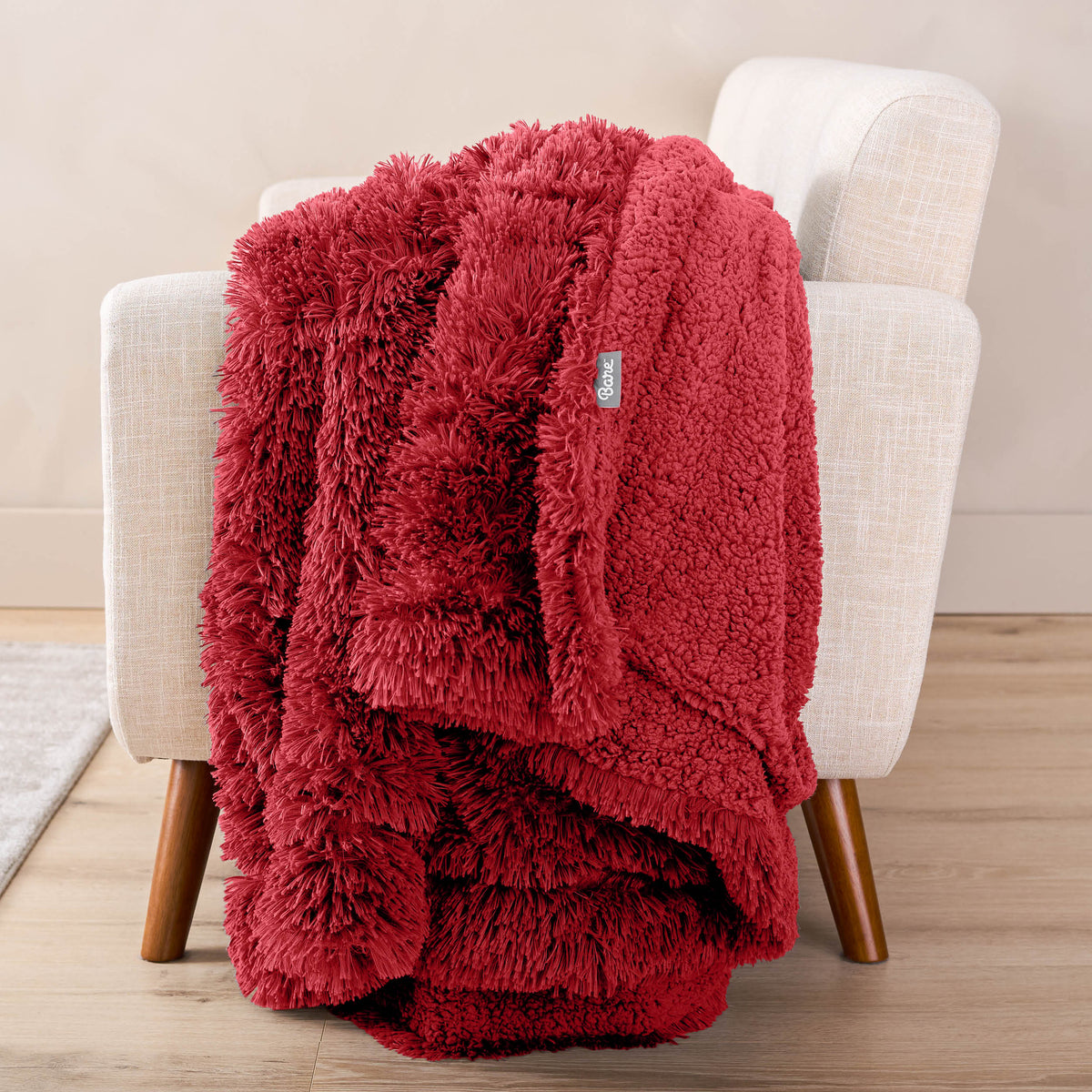A shaggy blanket draped over the arm of a chair