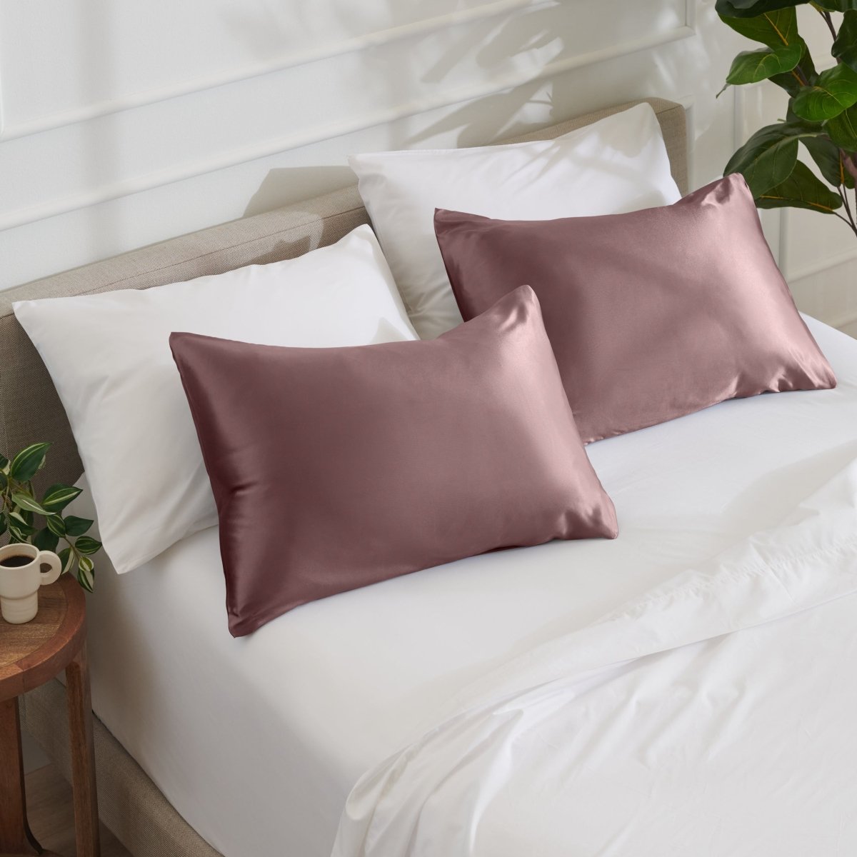 Satin pillowcases on a bed with white bedding