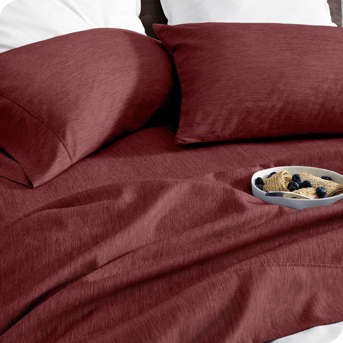 Bedding set on a bed with a bowl of cereal on a white background