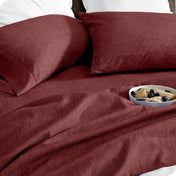 Bedding set on a bed with a bowl of cereal on a white background