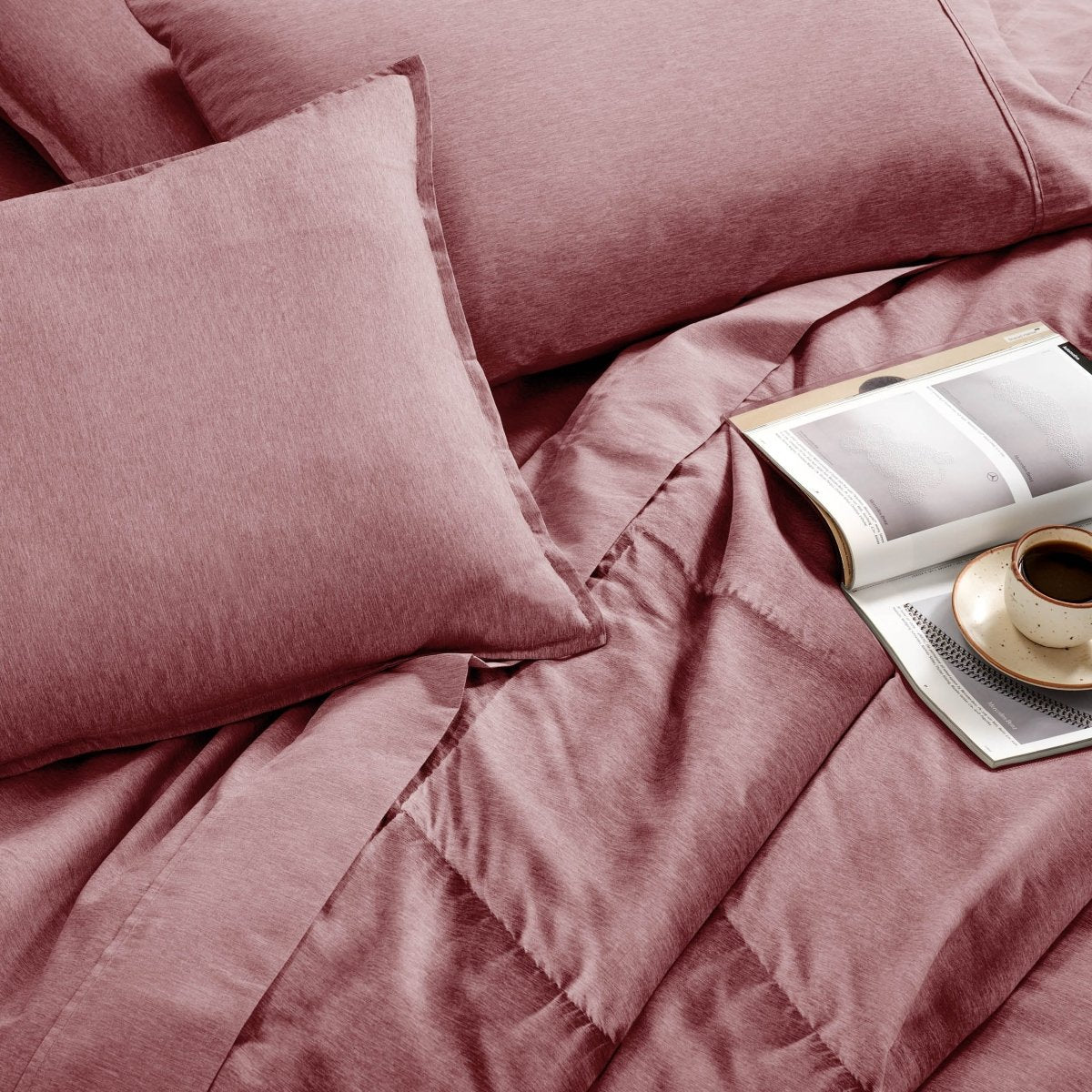 Bedding set with an open book and a cup on a saucer.