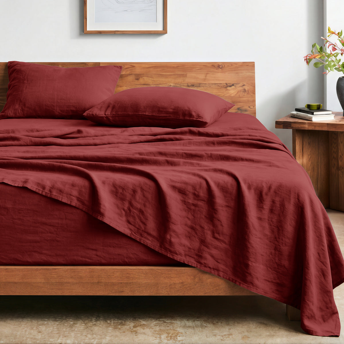 Bed with washed sheets and wooden headboard in a bedroom setting