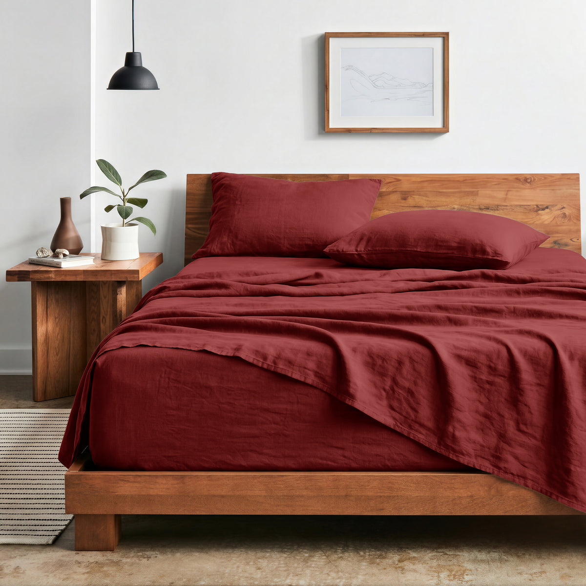 Bedroom with sheet set on a wooden bed frame and side table
