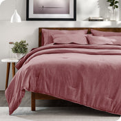 Modern bedroom with a heathered complete bedding set on the bed
