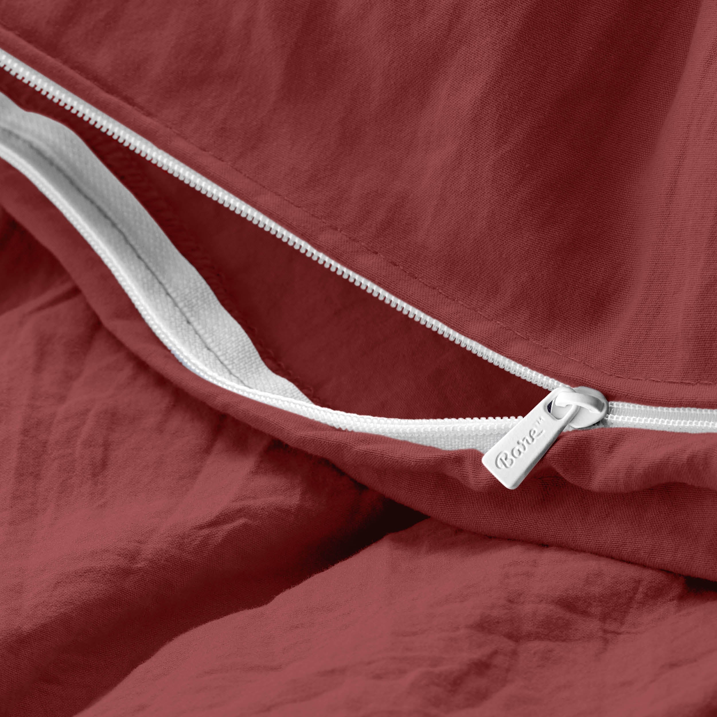 Close-up of a duvet cover with a zipper, featuring the brand Bare Home
