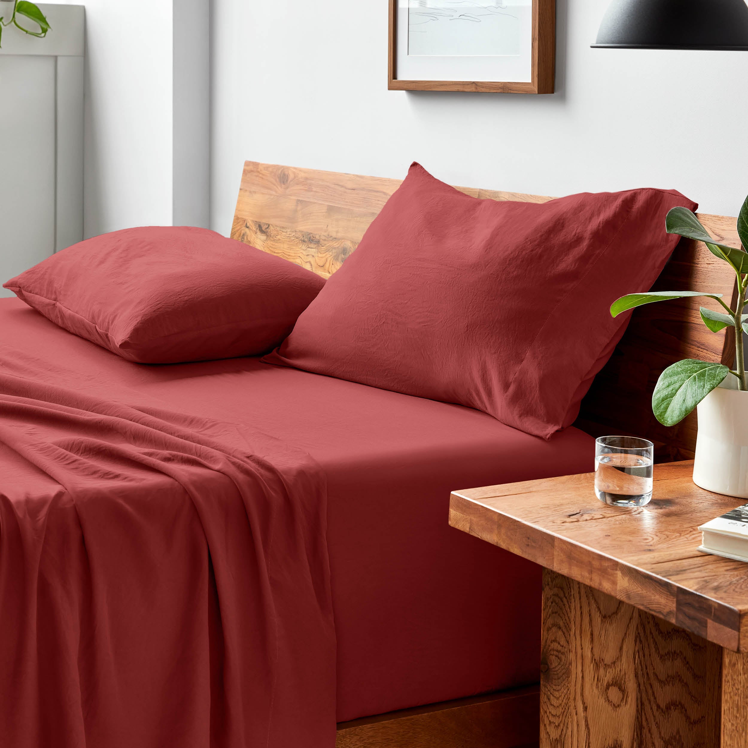 Bed with microfiber bedding and pillows in a bedroom setting