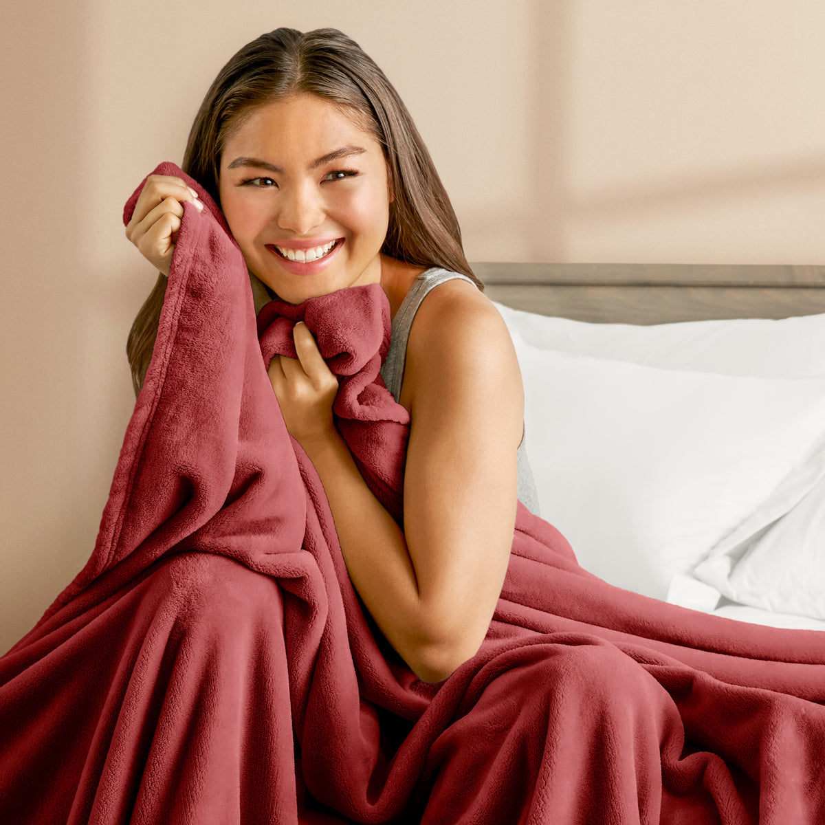 A woman cuddling with a microplush blanket