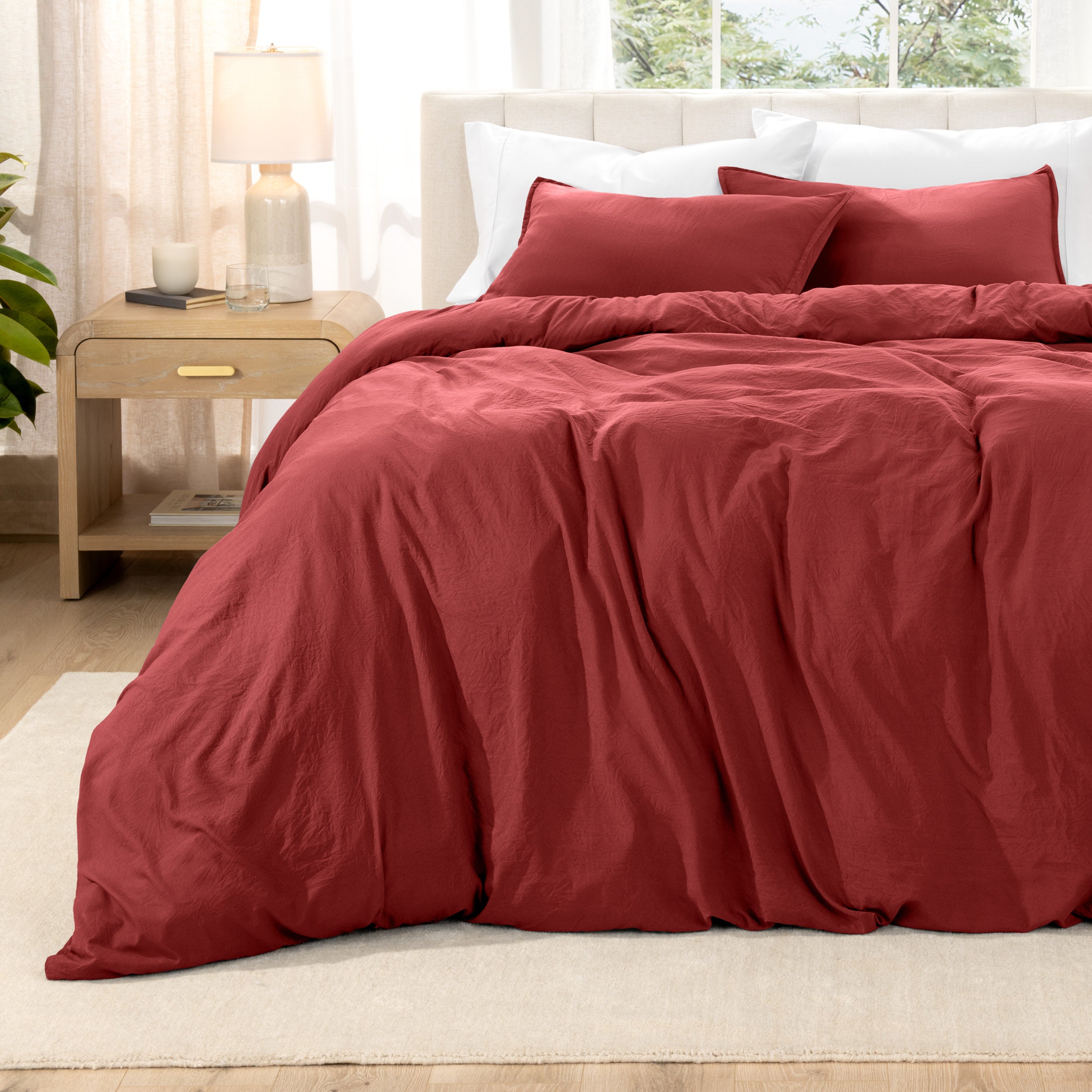 Washed bedding set on a bed with a nightstand in the background