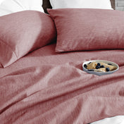 Bedding set on a bed with a bowl of cereal on a white background