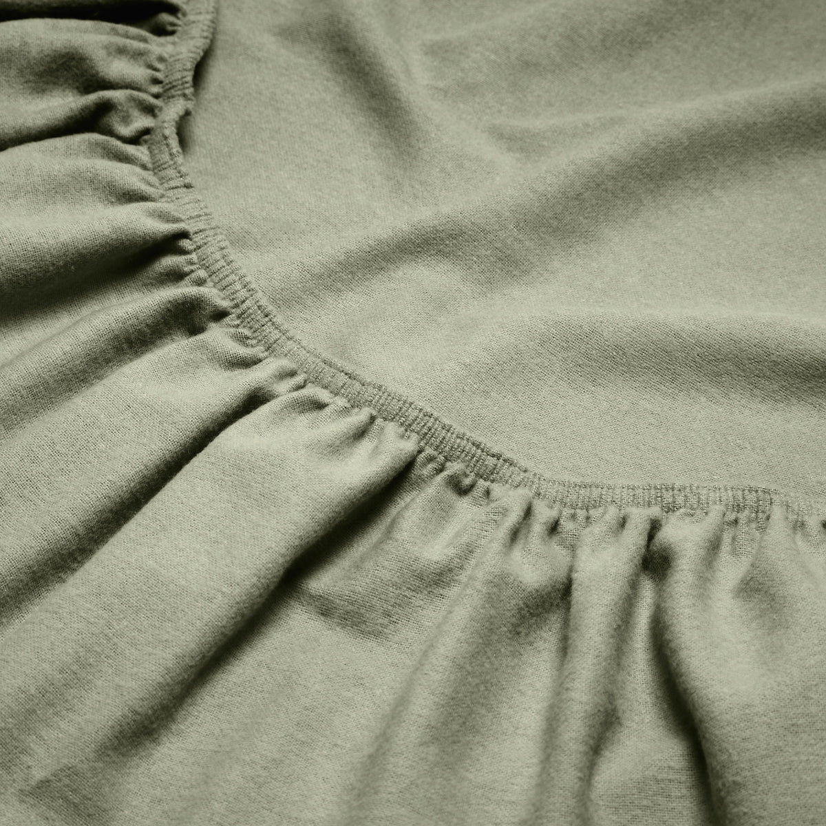 Close-up of a flannel fitted sheet with gathered elastic