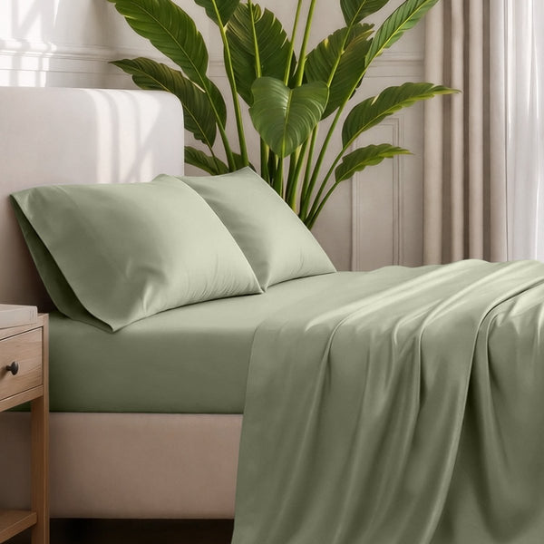 Ultra-soft sheets and pillowcases on a bed with a plant in the background
