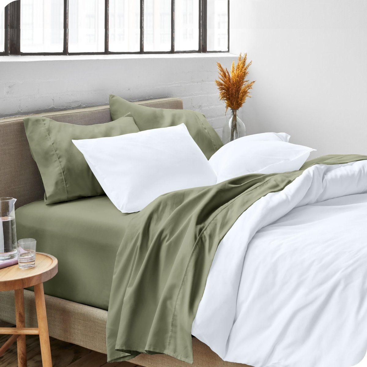 A side view of a bed made with microfiber sheets and a white duvet cover