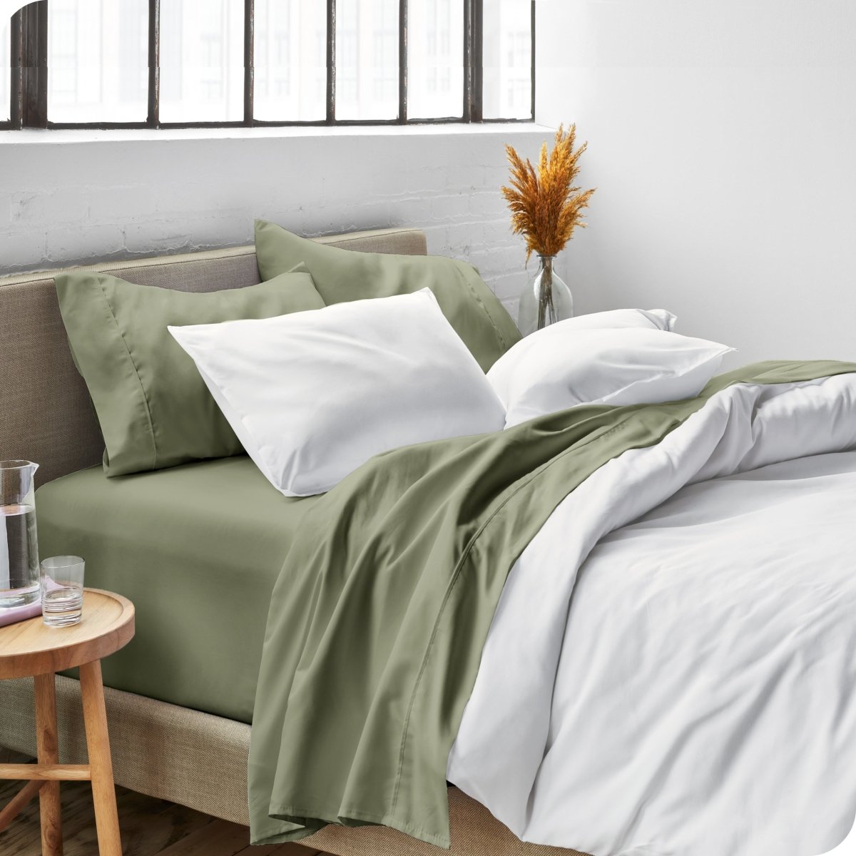 Sheets and a duvet cover on a bed in a bright bedroom