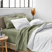 Sheets and a duvet cover on a bed in a bright bedroom