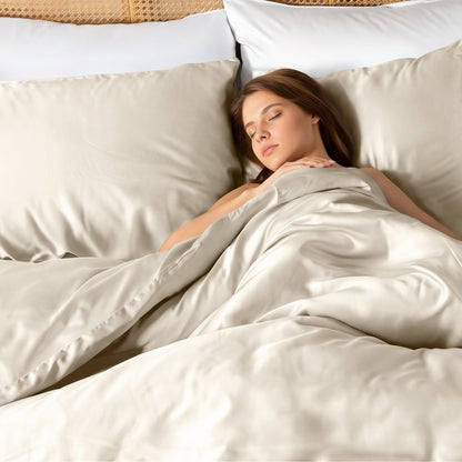 A woman sleeping with bamboo sheets, pillowcases and duvet set on the bed.