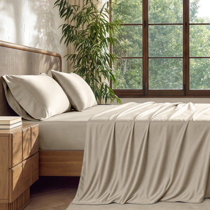 A brightly lite bedroom with bamboo sheets on the bed.