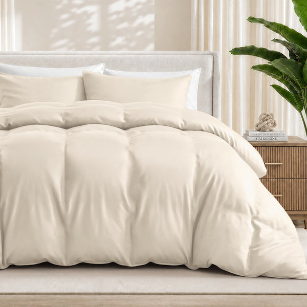 Sand duvet cover set on a bed in a bedroom setting with a plant and nightstand.
