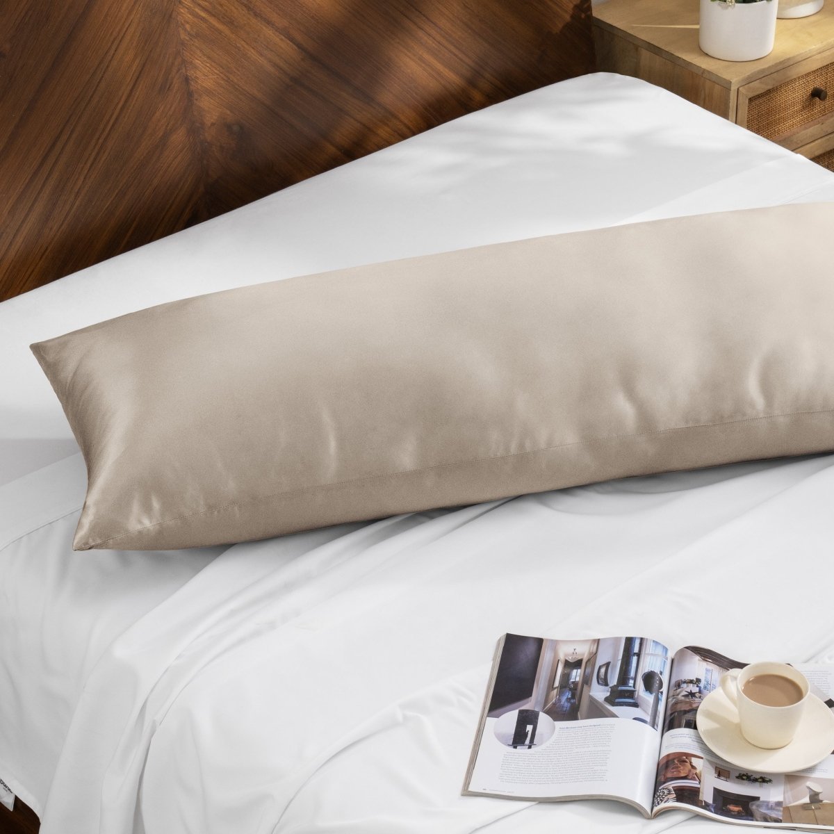 Bamboo pillow on a bed with a magazine and cup of coffee on a wooden nightstand.