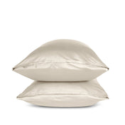 Two sand pillows stacked on a white background