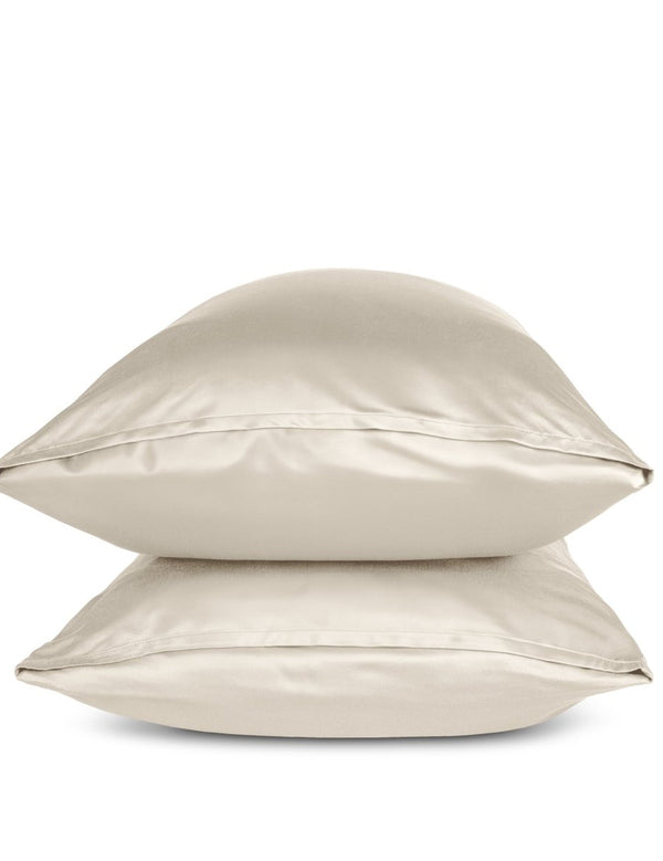 Two sand pillows stacked on a white background