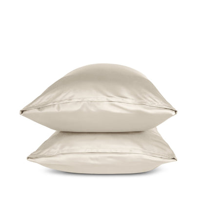 Two sand pillows stacked on a white background