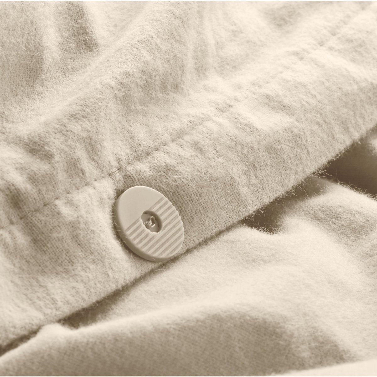 Close up of the button closure on a flannel duvet cover