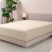 A modern bed with a flannel fitted sheet on