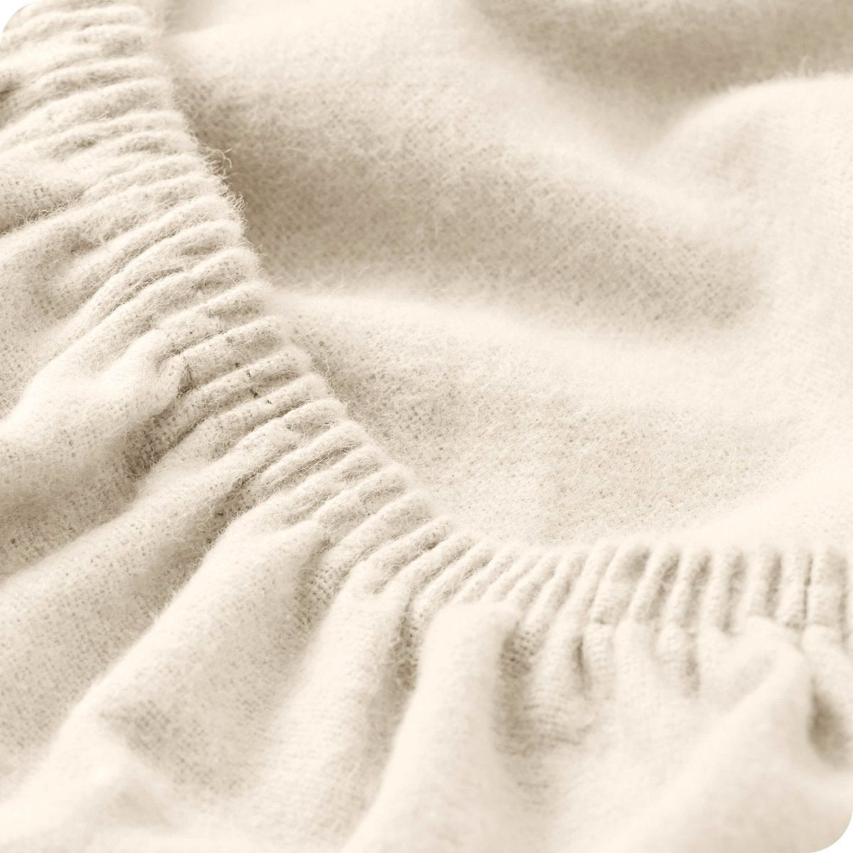 Close up of the elastic portion of a flannel fitted sheet