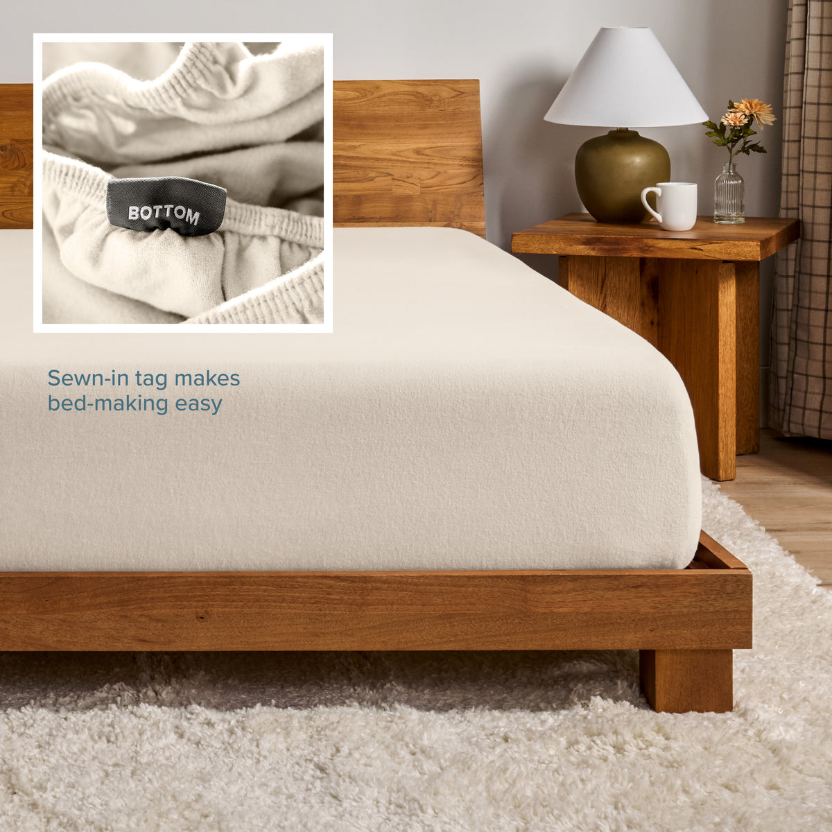 A flannel fitted sheet on a mattress with a wooden bed frame
