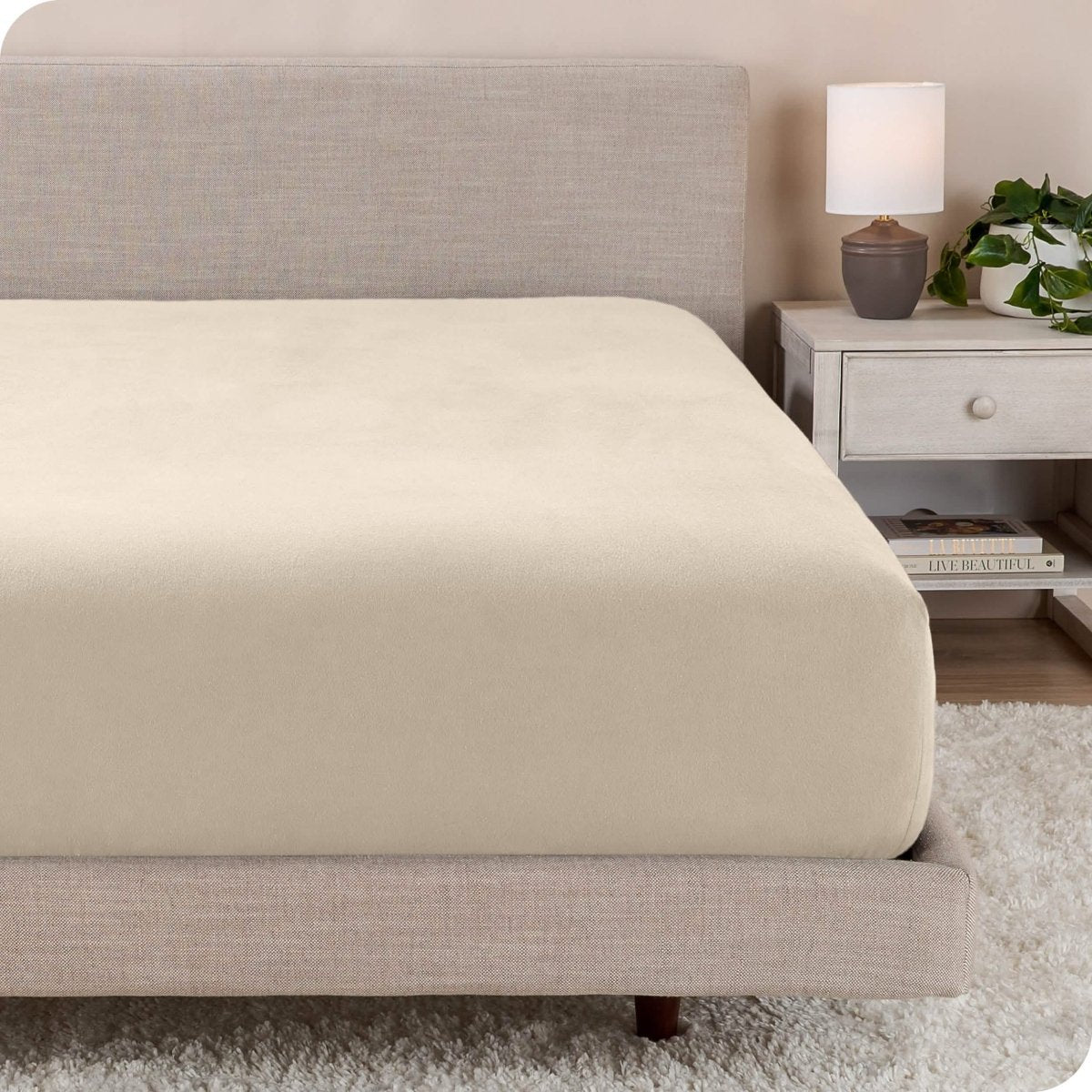 A close up of a modern bed with a flannel fitted sheet on