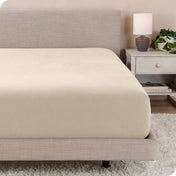 A close up of a modern bed with a flannel fitted sheet on
