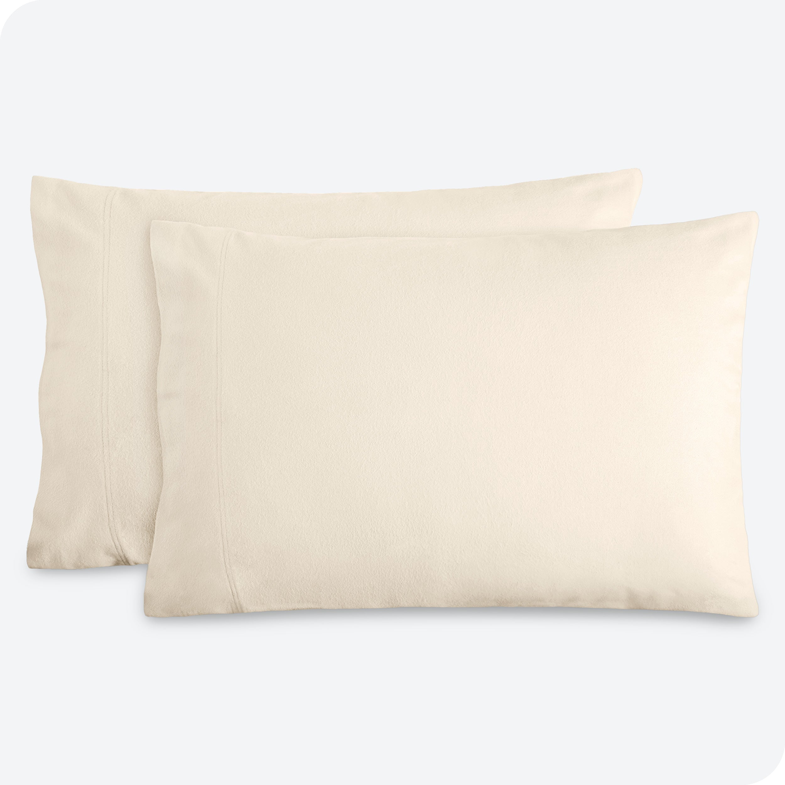 Two pillows with flannel pillowcases on them