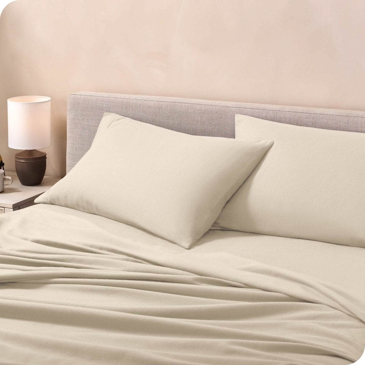 Flannel pillowcases on a mattress leaning against the headboard