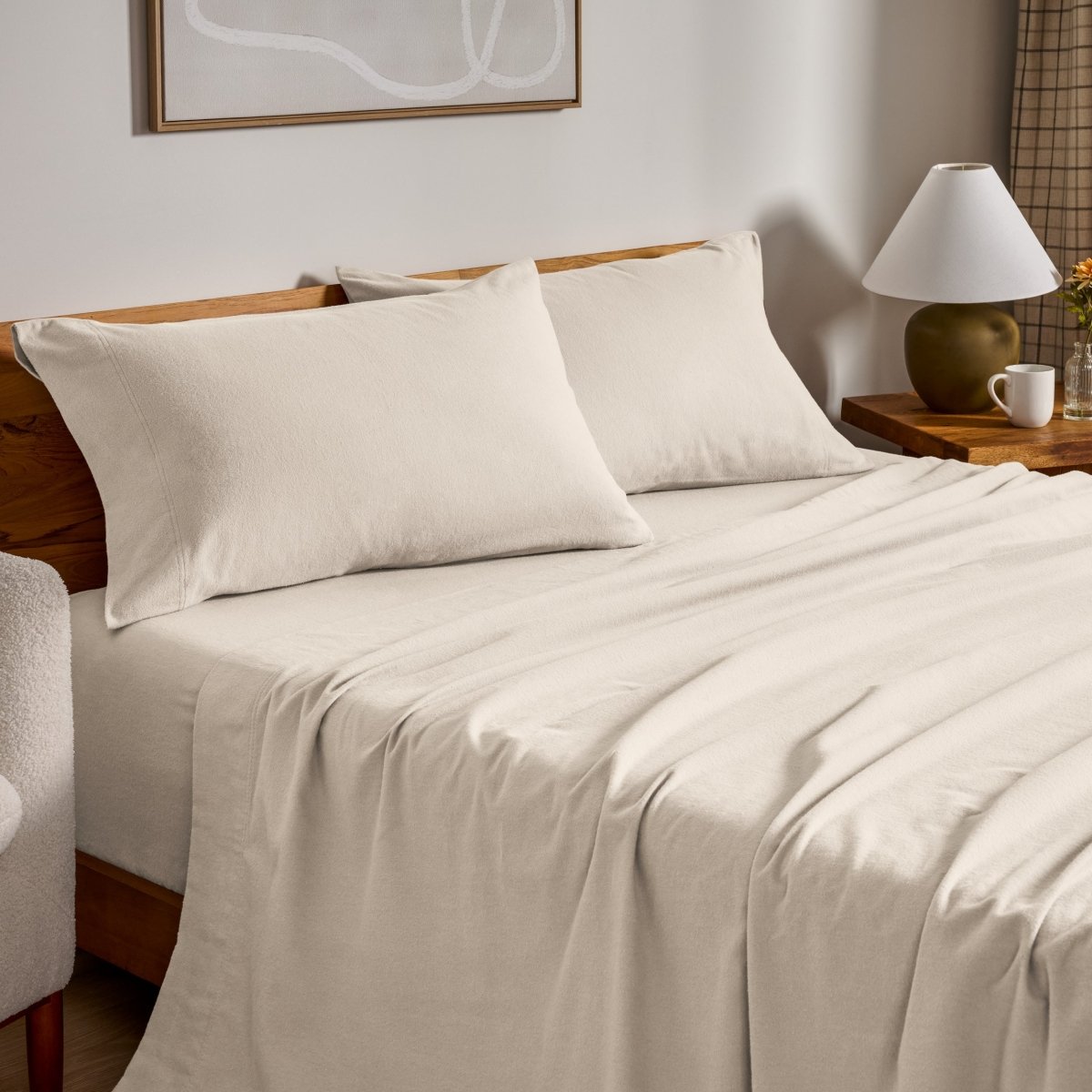 Flannel bed sheets and pillowcases on a bed in a bedroom setting.
