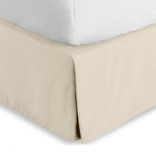 Bed skirt on a bed with white bedding