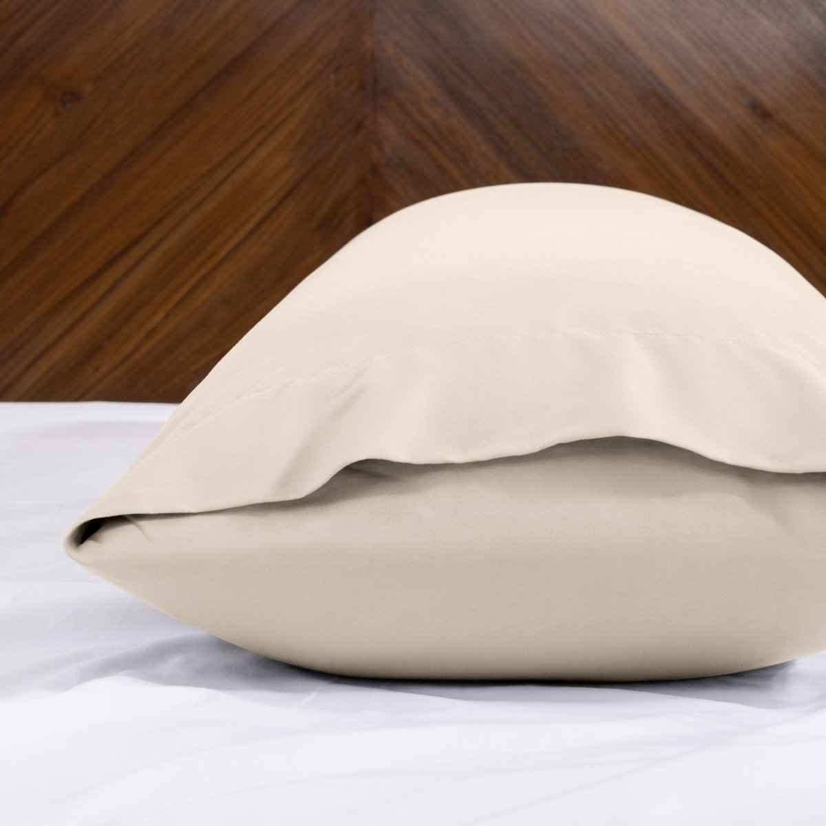 Body pillowcase with an envelope closure on a bed with a wooden headboard
