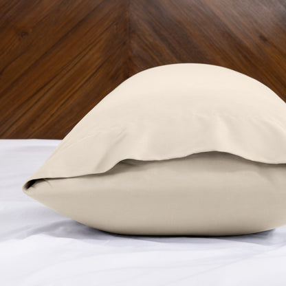 Body pillowcase with an envelope closure on a bed with a wooden headboard