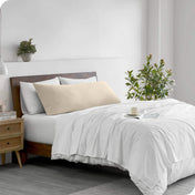 A body pillowcase on a pillow on a bed in a modern bedroom