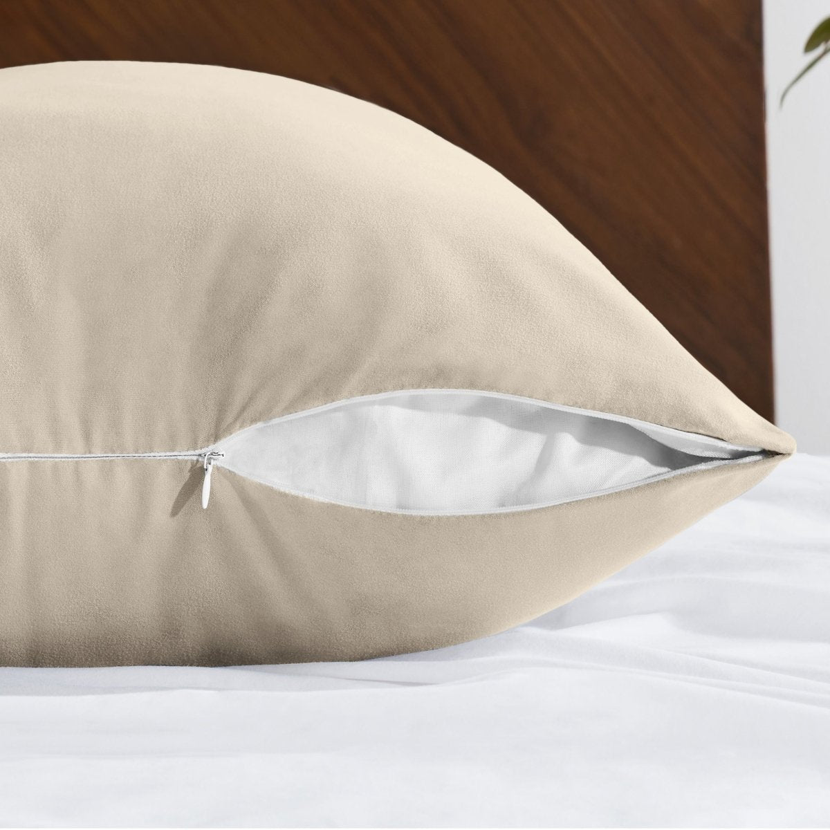 Body pillowcase with a zipper closure on a bed with a wooden headboard