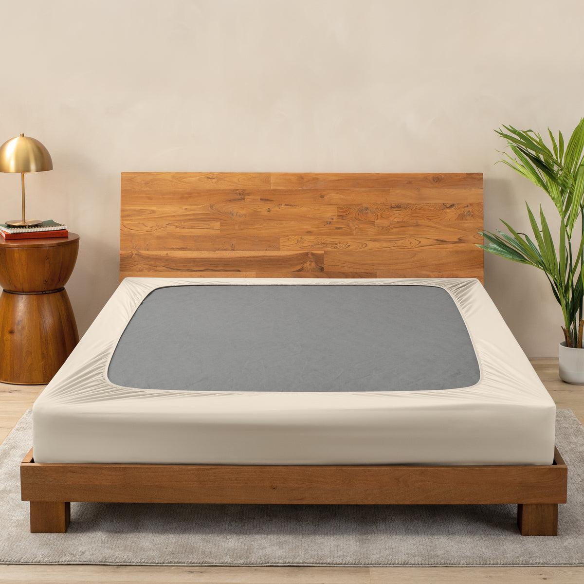 A cover on a box spring set on a wooden bed frame