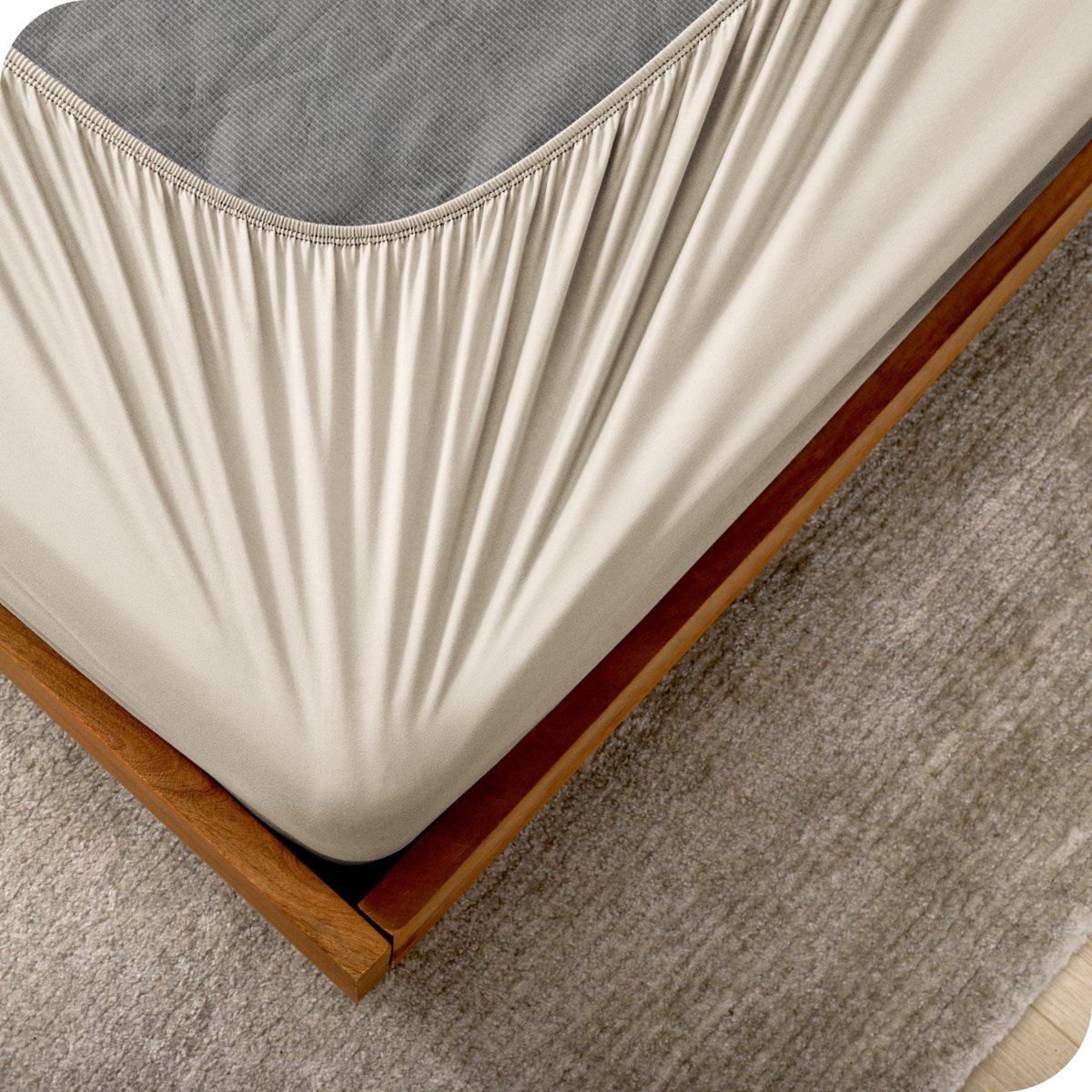 The corner of a box spring with a cover on it