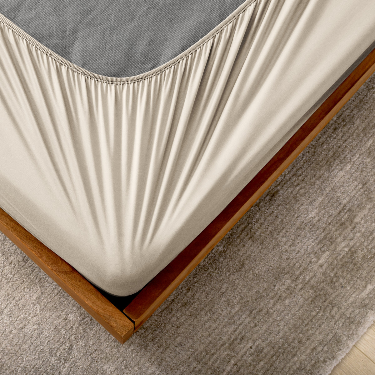 The corner of a box spring with a cover on it