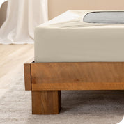 Close up of the corner of a bed frame with a cover box spring 